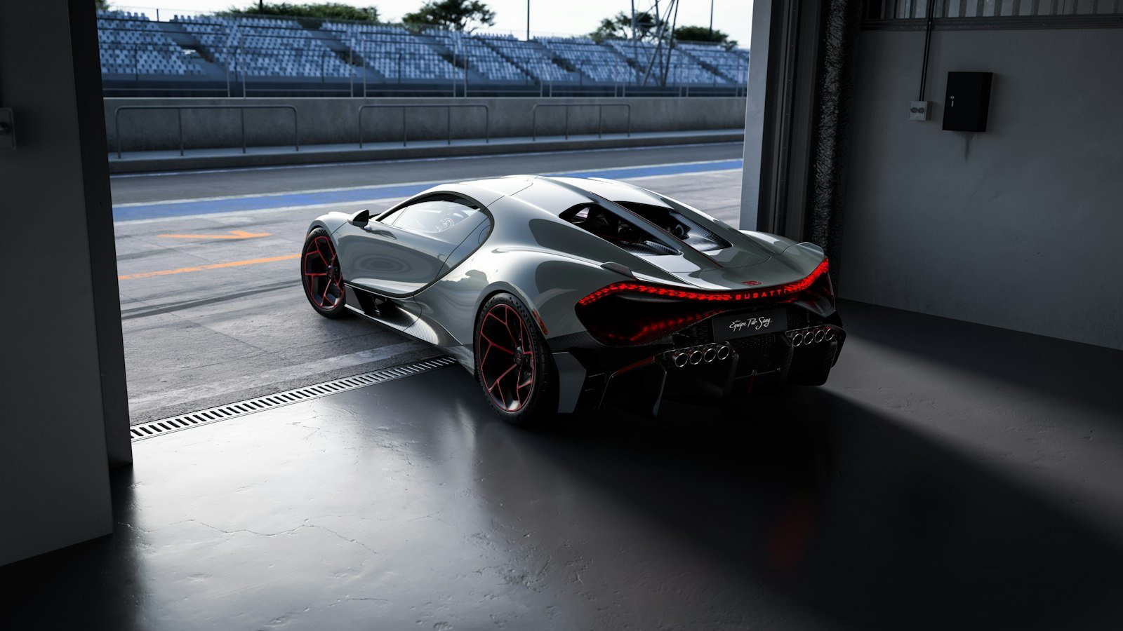 Silver Bugatti Tourbillon Équipe Pur Sang seen from the rear in a pit garage, showing its eight exhaust tips and red light bar