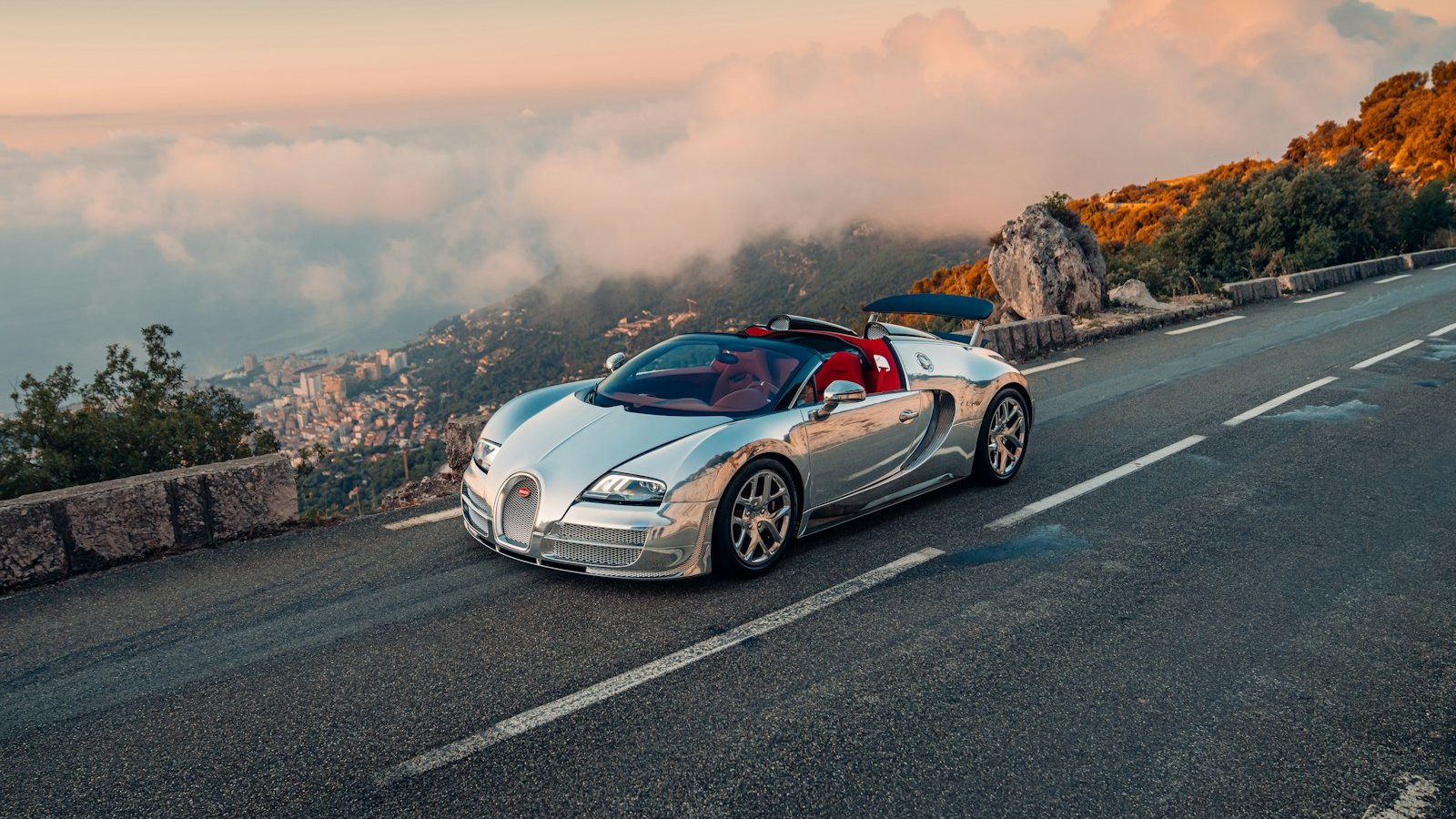 The aluminum Veyron Grand Sport Vitesse driving on a mountain road above the clouds