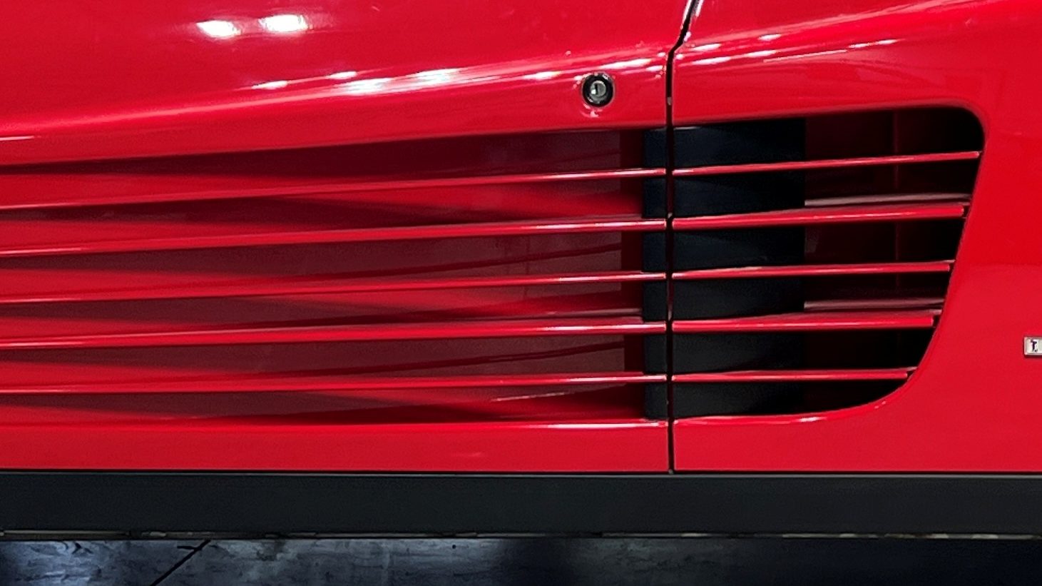 Close-up of the side strakes and new rear fairing on the red Testarossa during the build
