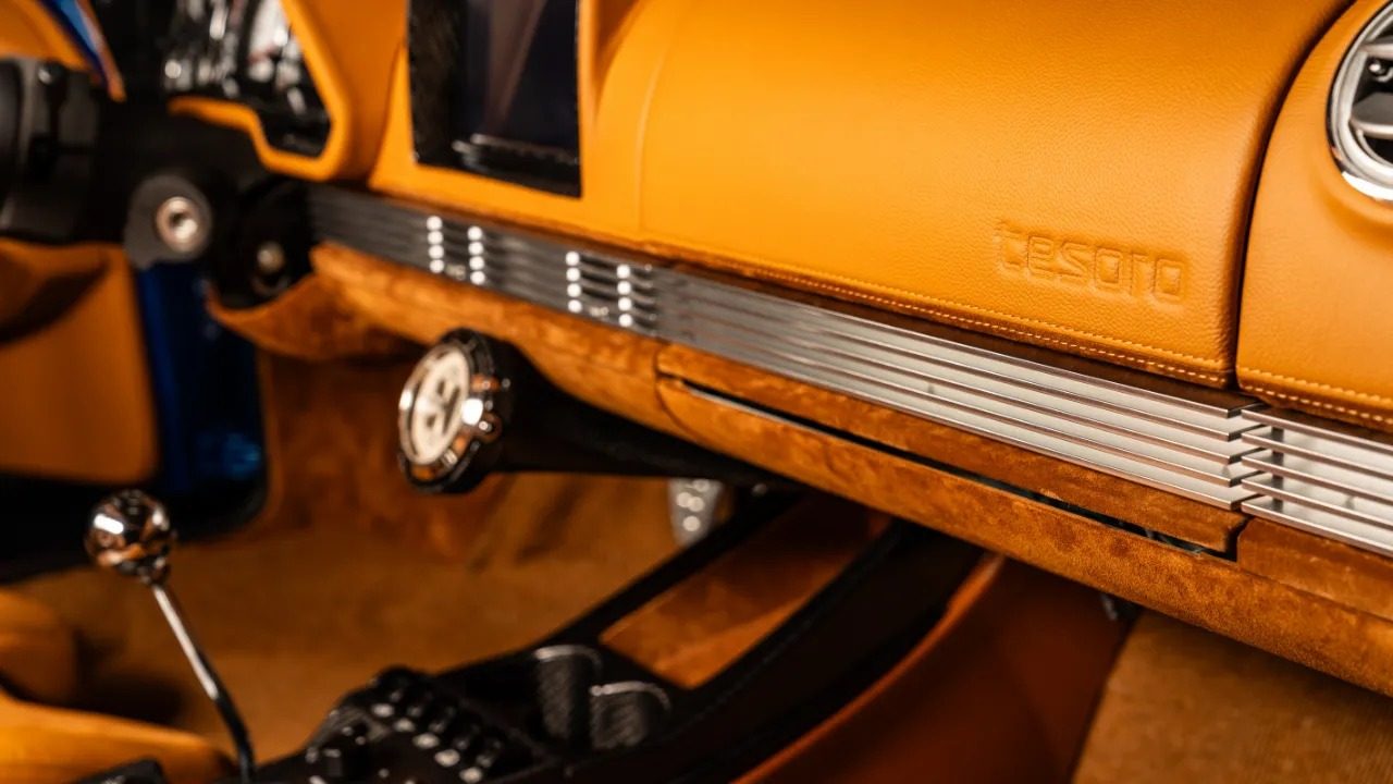 Tan leather dashboard and console of the Tesoro with the gated shifter and embossed tesoro script