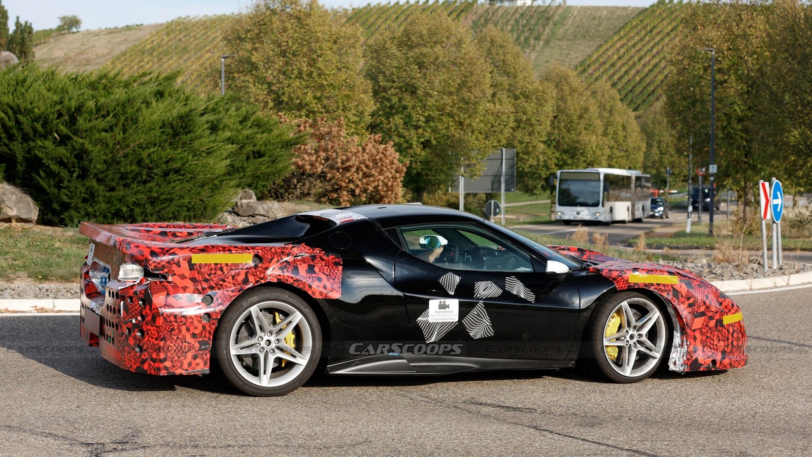Side profile of the camouflaged 296 Challenge Stradale prototype showing Challenge-style side skirts and intake