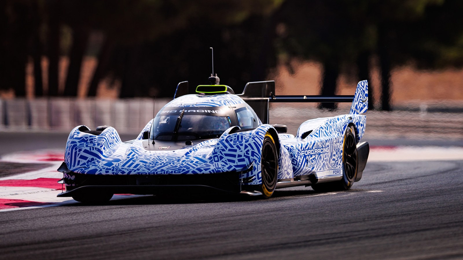 Front three-quarter view of the camouflaged Ford Le Mans Hypercar prototype cornering at Paul Ricard