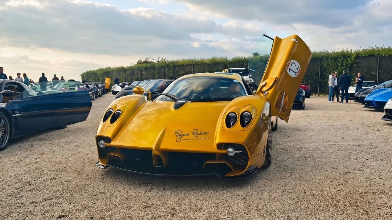 Gold one-off Pagani Utopia with its gullwing door raised, parked among other Paganis at the 2026 Pagani Raduno Vanishing Point in Sicily